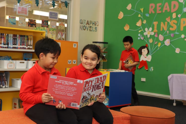 Students reading book together