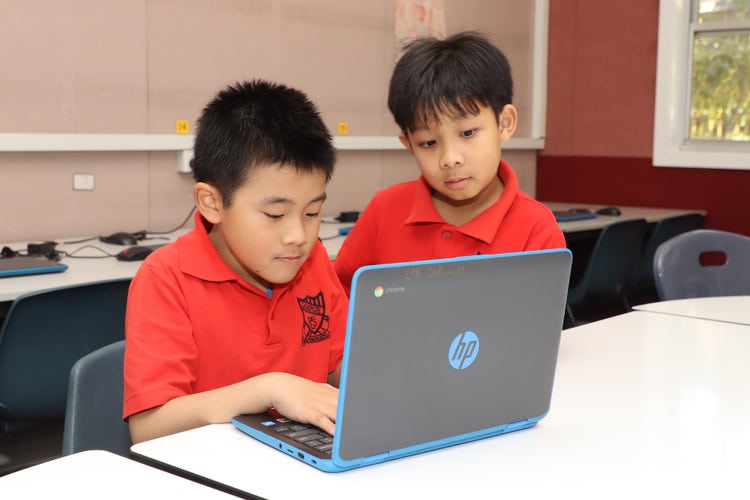 Two students working on computer together