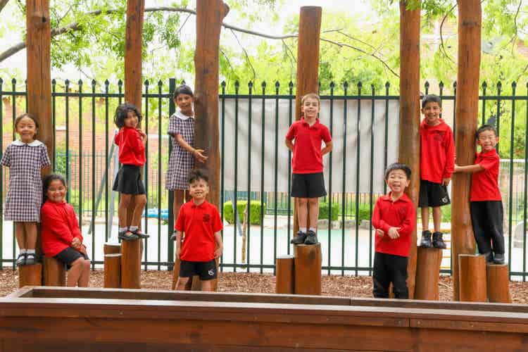 Students standing on poles