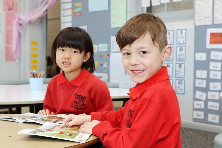 Two students reading together