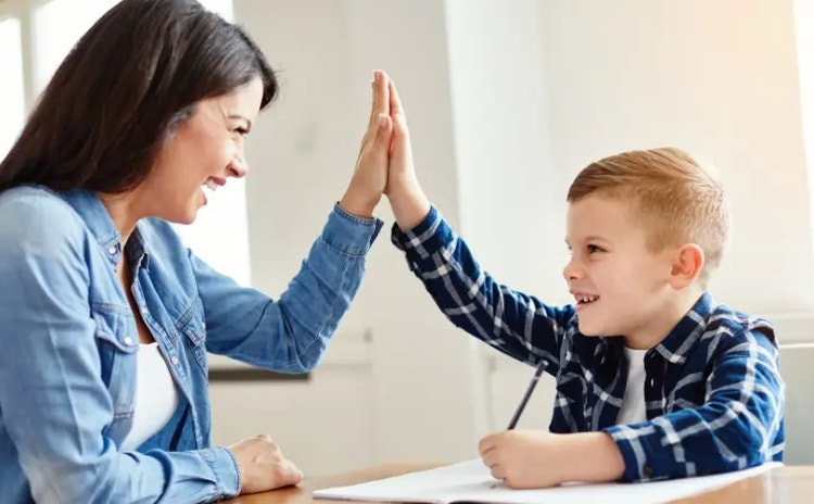 Student high fives teacher